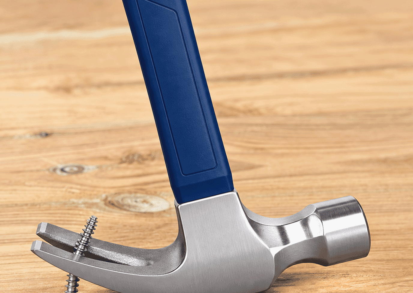 Claw hammer being used to loosen a screw with no head