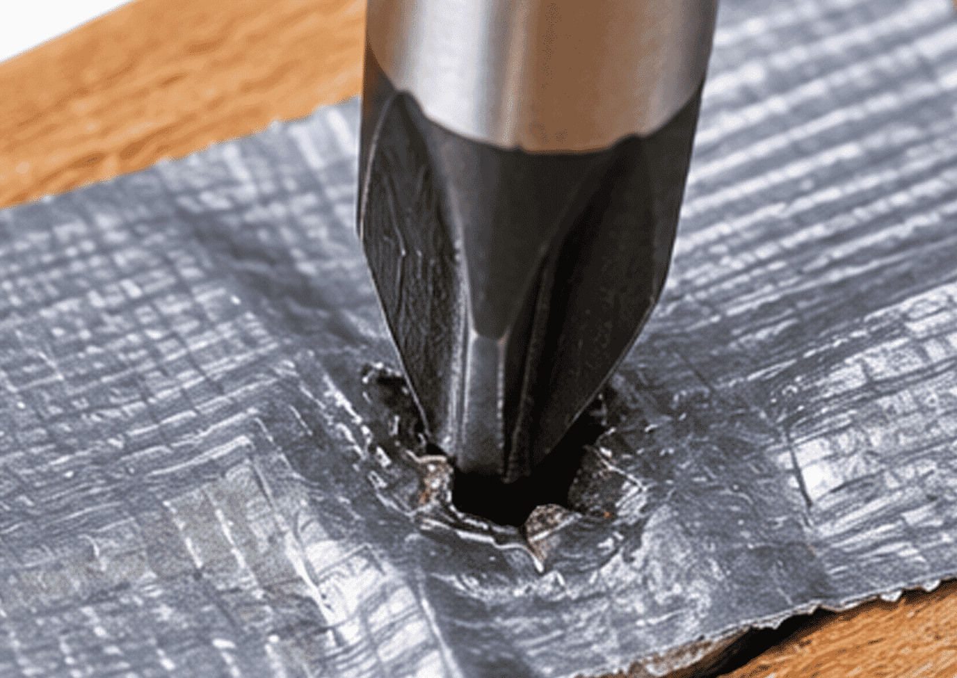 Duct tape applied over a stripped screw before using a screwdriver