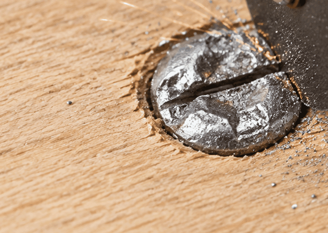 Rotary tool cutting a new slot into a stripped screw head